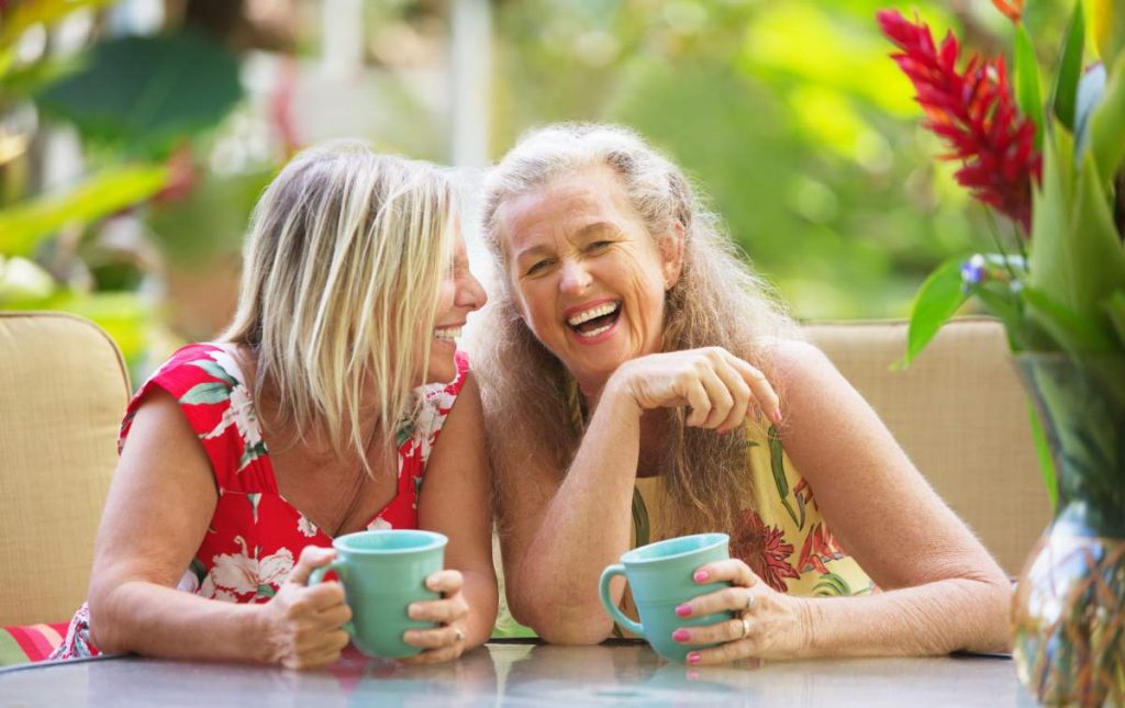 Mature women friends laughing on holiday in our Top Tips for Travelling with COPD