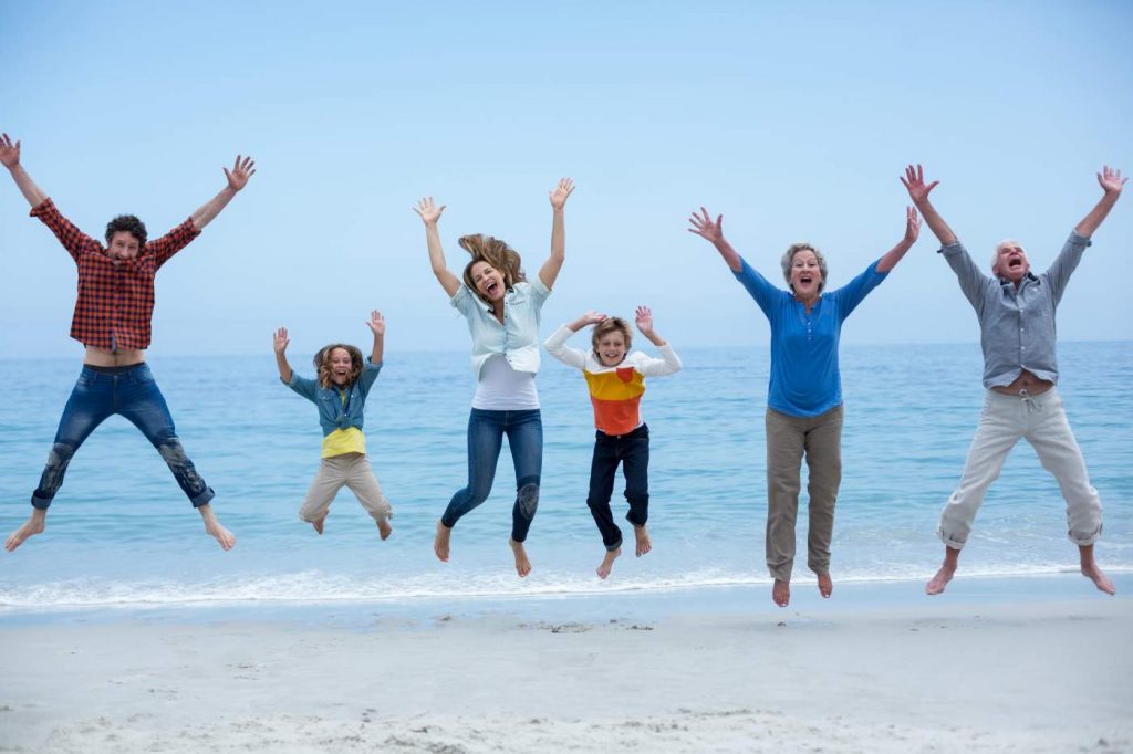 Family jumping for joy on the beach