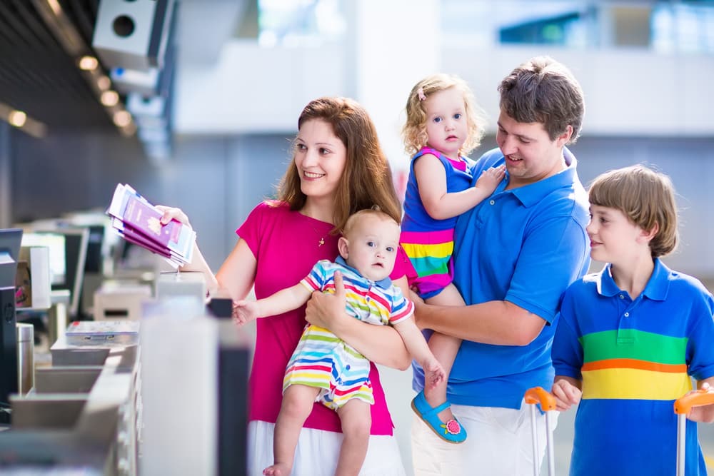 Travelling With Medications | Hand Luggage Restrictions: How to pack your hand luggage: Family showing passports at airport