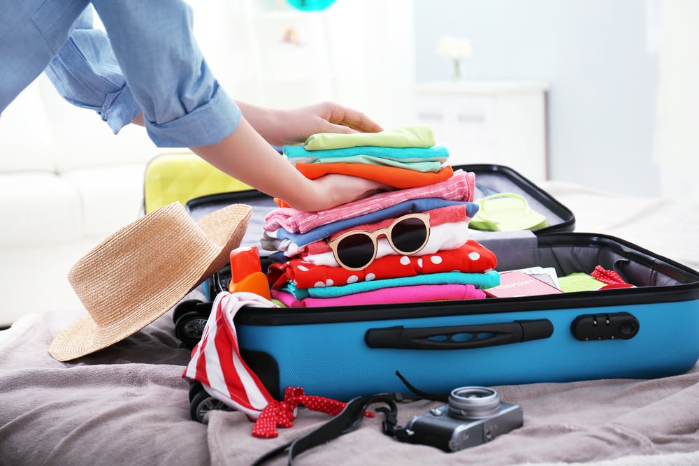 Preparing for a holiday when you have a medical condition: A woman packing her suitcase