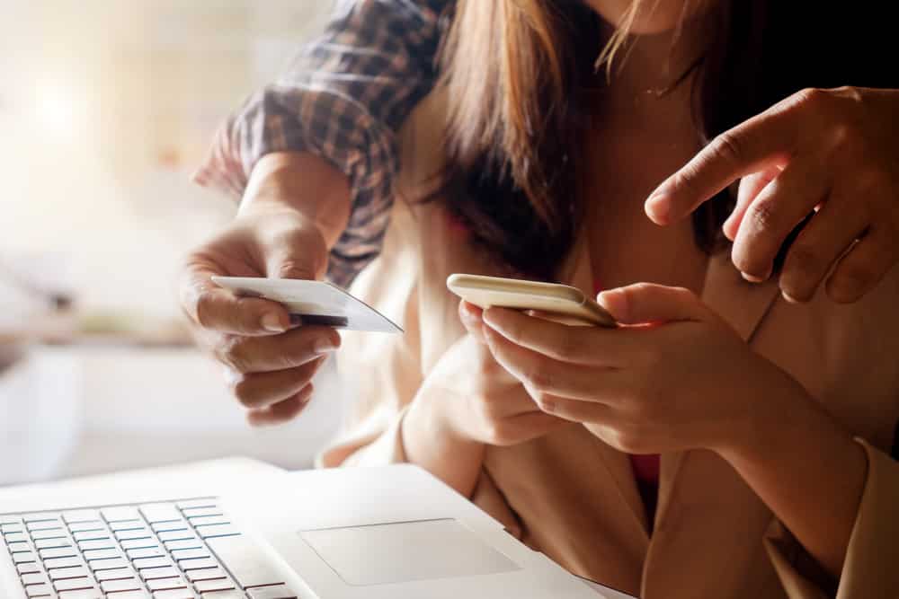 Preparing for a holiday with a medical condition: Couple using their laptop to make a payment