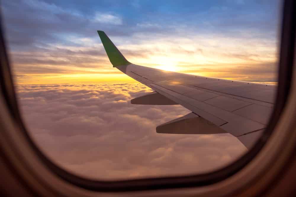 Preparing for a holiday when you have a medical condition: Looking of plane window into the clouds